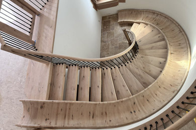 Inspiration for a large craftsman wooden curved open and metal railing staircase remodel in Sacramento