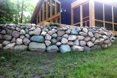 Design ideas for a rustic front yard stone vegetable garden landscape in Other.