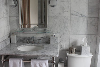 Example of a mid-sized classic 3/4 gray tile and marble tile marble floor and gray floor bathroom design in Other with a one-piece toilet, gray walls, an undermount sink, marble countertops and open cabinets