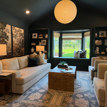 Moody Transitional Lounge with Layered Texture + Warm Ambient Lighting