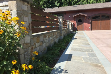 Inspiration for a large front yard stone retaining wall landscape in Seattle.