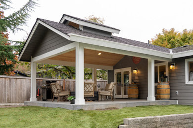 Inspiration for a mid-sized timeless concrete back porch remodel in Seattle with a fire pit and a roof extension