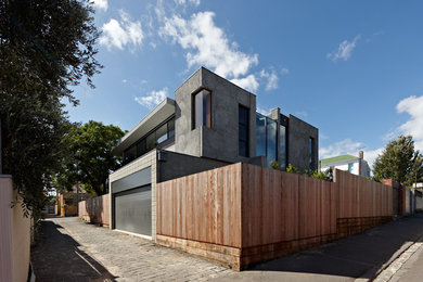 Photo of a large contemporary two-storey concrete grey exterior in Other with a flat roof.