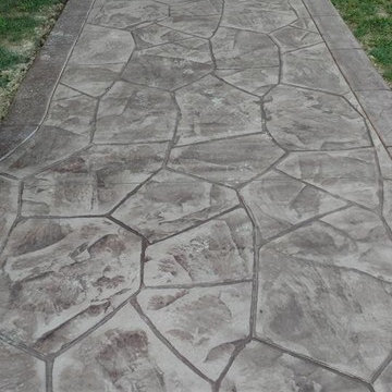 Stamped concrete patio with block seating wall and block fire-pit