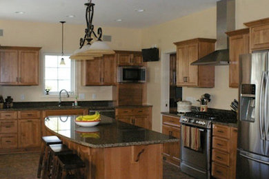 Large l-shaped kitchen pantry photo in Milwaukee with a drop-in sink, recessed-panel cabinets, medium tone wood cabinets, wood countertops, stainless steel appliances and an island