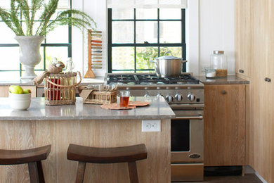Inspiration for a coastal dark wood floor kitchen remodel in New York with flat-panel cabinets, medium tone wood cabinets, stainless steel appliances and an island