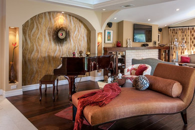 Large tuscan open concept dark wood floor living room photo in San Francisco with beige walls, a standard fireplace and a stone fireplace