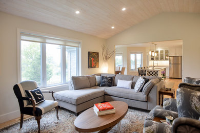 Mid-sized transitional open concept light wood floor family room photo in Toronto with beige walls and no fireplace