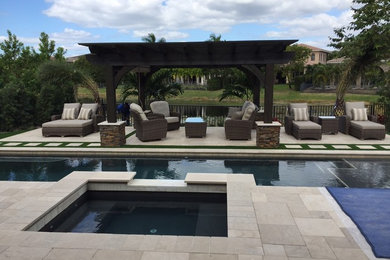 Example of a mid-sized transitional backyard patio design in Chicago with a pergola