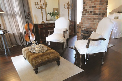 Inspiration for a large timeless master dark wood floor bedroom remodel in Miami with beige walls, a ribbon fireplace and a brick fireplace