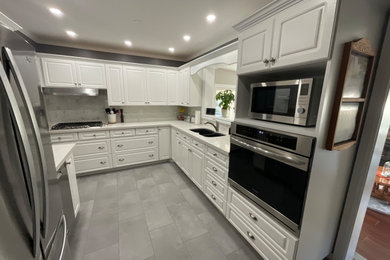 Inspiration for a gray floor kitchen remodel in Toronto with a double-bowl sink, white backsplash, stainless steel appliances, no island and white countertops