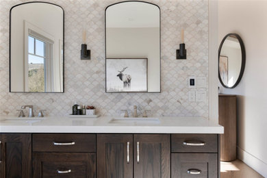 Large transitional multicolored tile and marble tile porcelain tile and double-sink bathroom photo in Salt Lake City with shaker cabinets, brown cabinets, a bidet, white walls, an undermount sink, quartz countertops, a hinged shower door and white countertops