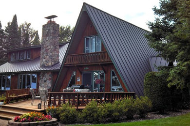 Inspiration for a large scandinavian brown two-story wood gable roof remodel in Other