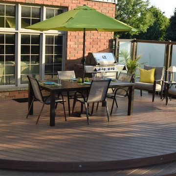 This custom Hickory Dickory Decks shows curves are in with low maintenance Veka.