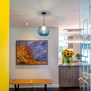 Design ideas for a small eclectic entryway in Toronto with beige walls, dark hardwood floors, a single front door, a yellow front door and brown floor.