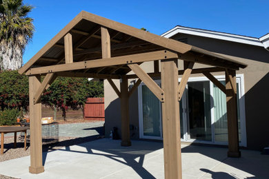 Inspiration for a large craftsman backyard concrete patio remodel in San Diego with a gazebo