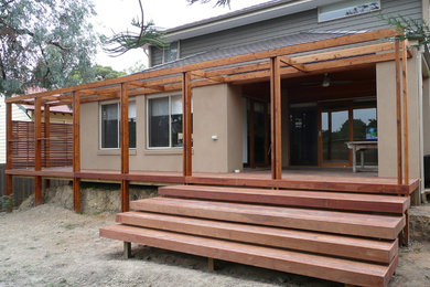 This is an example of a mid-sized modern home design in Melbourne.