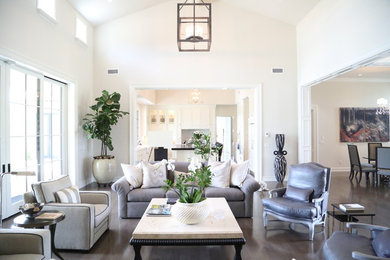 This is an example of a large transitional formal open concept living room in Phoenix with white walls, dark hardwood floors, no fireplace, no tv and brown floor.