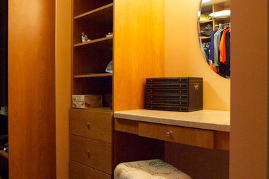 Elegant dark wood floor closet photo in Chicago with medium tone wood cabinets