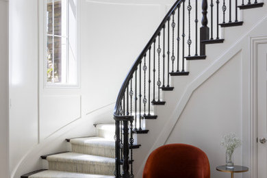 Example of a huge trendy marble floor, beige floor and wall paneling foyer design in San Francisco with white walls