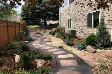 This is an example of a small contemporary drought-tolerant and partial sun side yard stone walkway in Denver for summer.