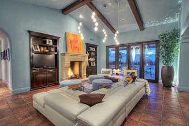 Huge minimalist open concept terra-cotta tile family room photo in Orange County with blue walls, a standard fireplace, a stone fireplace and a media wall