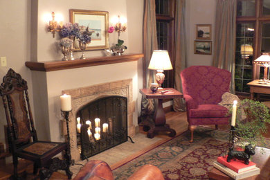 Inspiration for a mid-sized timeless formal and enclosed medium tone wood floor living room remodel in Seattle with white walls, a standard fireplace, a stone fireplace and no tv