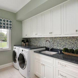 Design ideas for a traditional single-wall separated utility room in Chicago with a double-bowl sink, recessed-panel cabinets, white cabinets, granite worktops, porcelain flooring, a side by side washer and dryer and grey walls.