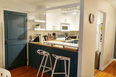 Example of a mid-sized trendy eat-in kitchen design in Ottawa with flat-panel cabinets