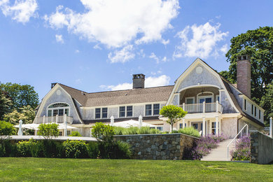 Large traditional gray two-story wood exterior home idea with a gambrel roof