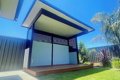 Inspiration for a contemporary backyard and ground level deck in Adelaide with a roof extension.