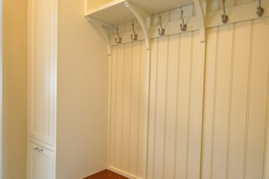 Example of a mid-sized farmhouse ceramic tile laundry room design in Philadelphia with white walls