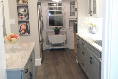 Enclosed kitchen - mid-sized craftsman galley vinyl floor and gray floor enclosed kitchen idea in Portland with an undermount sink, shaker cabinets, gray cabinets, granite countertops, white backsplash, marble backsplash, stainless steel appliances, a peninsula and gray countertops