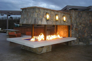 Patio - mid-sized traditional backyard stamped concrete patio idea in Omaha with a fire pit and no cover
