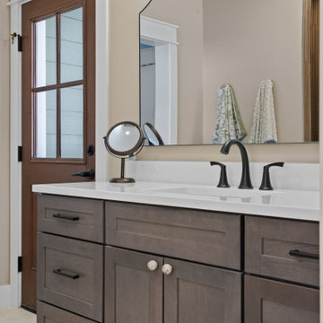 Warm and Cohesive Multi-Bathroom Design In Nokesville