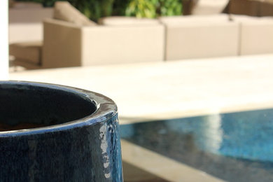 This is an example of a mid-sized contemporary backyard stone landscaping in Miami.