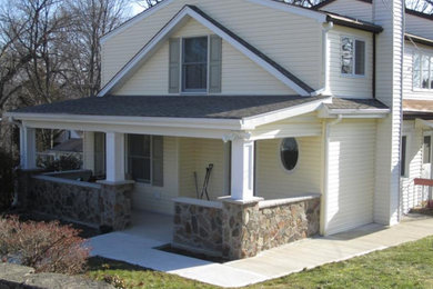 Inspiration for a yellow two-story exterior home remodel in New York