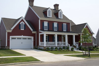 Inspiration for a large timeless red two-story vinyl gable roof remodel in Philadelphia