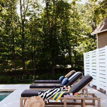 Pool Deck with Teak Lounge Chairs and Black Cushions