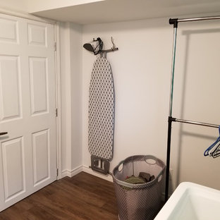 Inspiration for an utility room in Toronto with vinyl flooring, a side by side washer and dryer and brown floors.