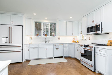 Eat-in kitchen - transitional l-shaped medium tone wood floor and brown floor eat-in kitchen idea in Other with a single-bowl sink, white cabinets, quartz countertops, white backsplash, quartz backsplash, white appliances, no island and white countertops