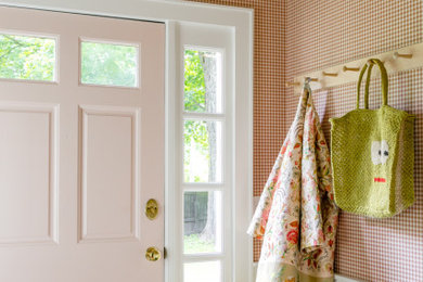 Mid-sized transitional concrete floor, gray floor, vaulted ceiling and wallpaper single front door photo in New York