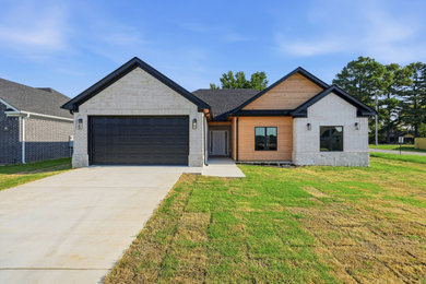 Inspiration for a mid-sized modern multicolored one-story brick exterior home remodel in Little Rock with a shingle roof and a black roof