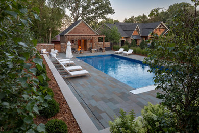 Inspiration for a large rustic backyard stone landscaping in Minneapolis for summer.