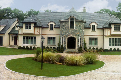 Example of a huge ornate beige two-story exterior home design in New York