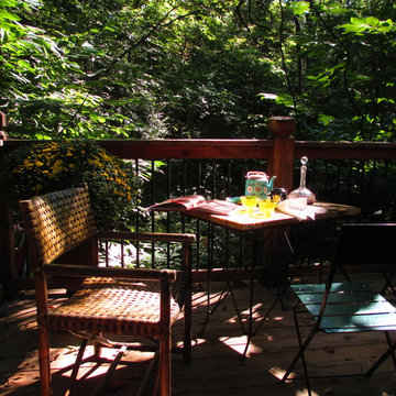 Small deck in the woods set for afternoon tea, and later for cocktails.
