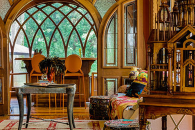 Ornate medium tone wood floor family room photo in Atlanta with orange walls