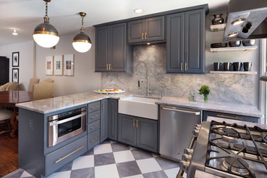 Photo of a traditional eat-in kitchen in DC Metro with a farmhouse sink, raised-panel cabinets, grey cabinets and stainless steel appliances.