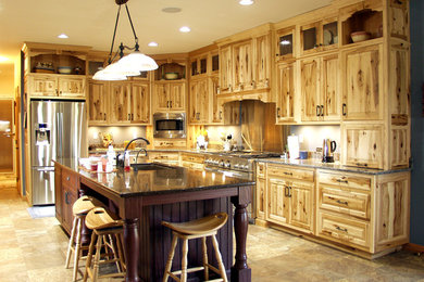Inspiration for a rustic kitchen remodel in Other with raised-panel cabinets, distressed cabinets, granite countertops and an island