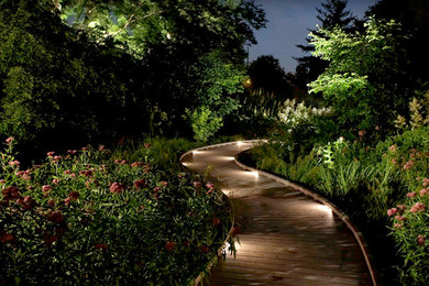Inspiration for a large contemporary partial sun courtyard landscaping in Other with decking for spring.